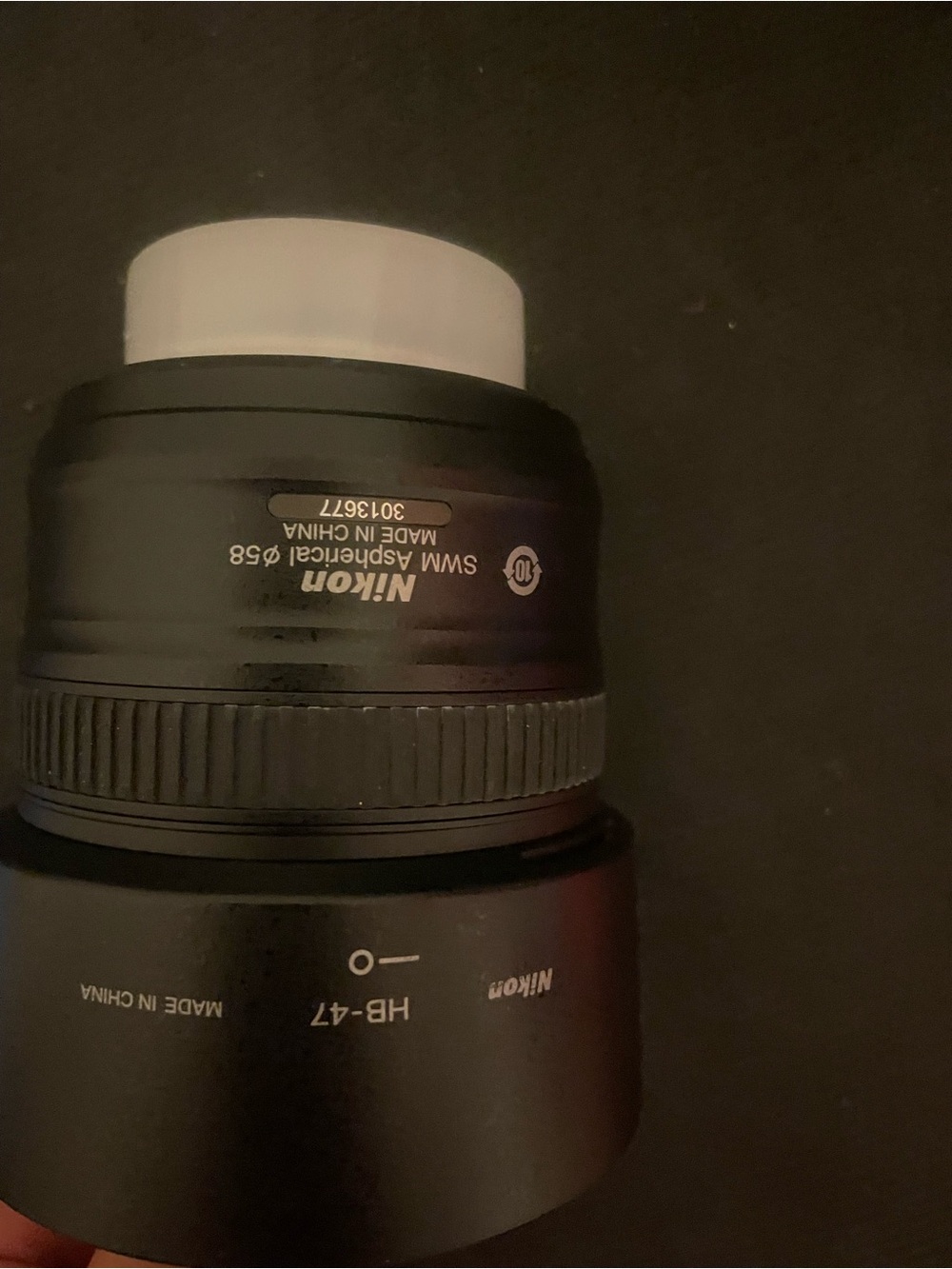 Nikon Black Lens with White Cap and Hood